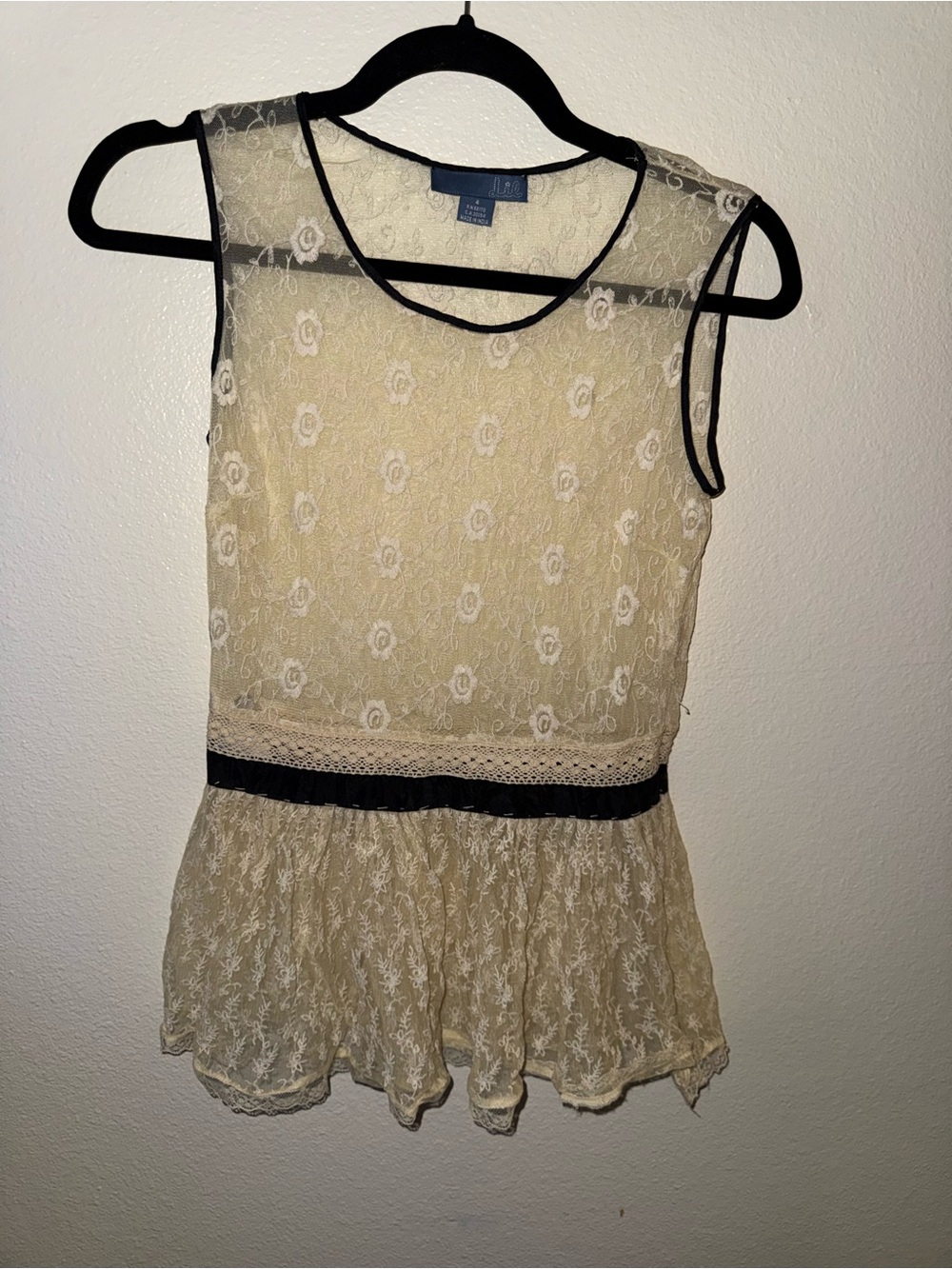 Sleeveless Lace Peplum Blouse with Black Trim - Cream